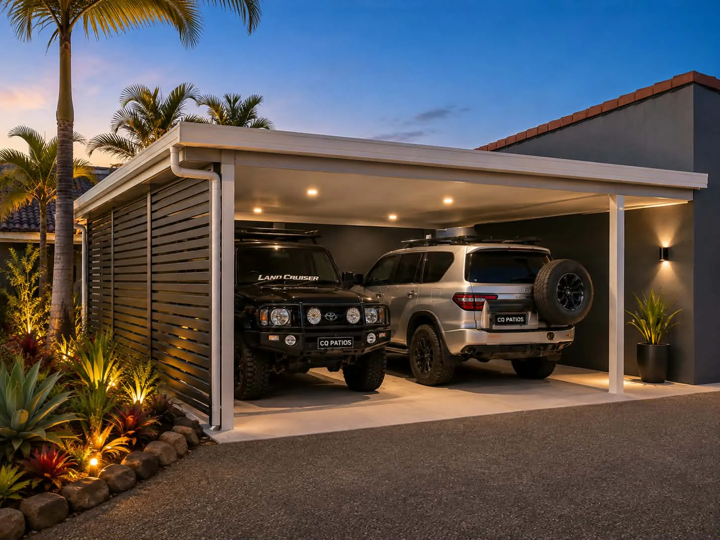 Two vehicles under a covered carport with privacy screening at the owners' current home